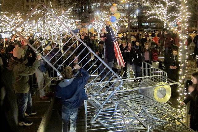 Protesters dismantle the barricades around Zuccotti Park on New Year's Eve, 2011